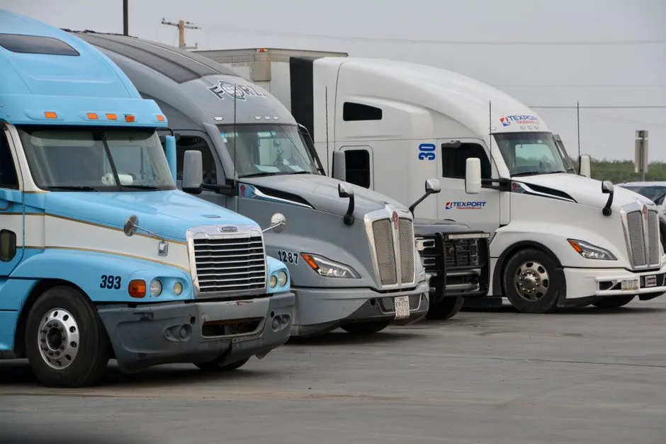 Lineup of commercial trucks representing the range of vehicle types covered by CDL endorsements